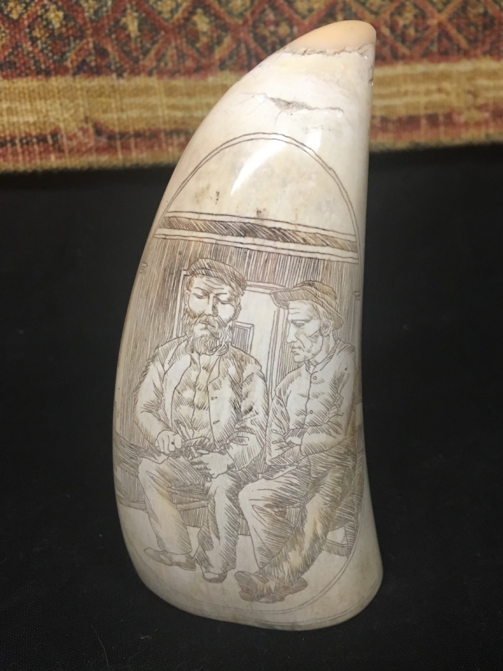 c19th scrimshaw on a whales tooth