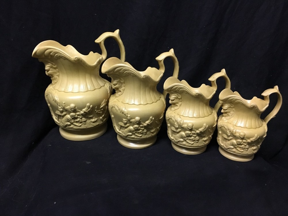 c19th graduated set of stoneware jugs depicting monkeys
