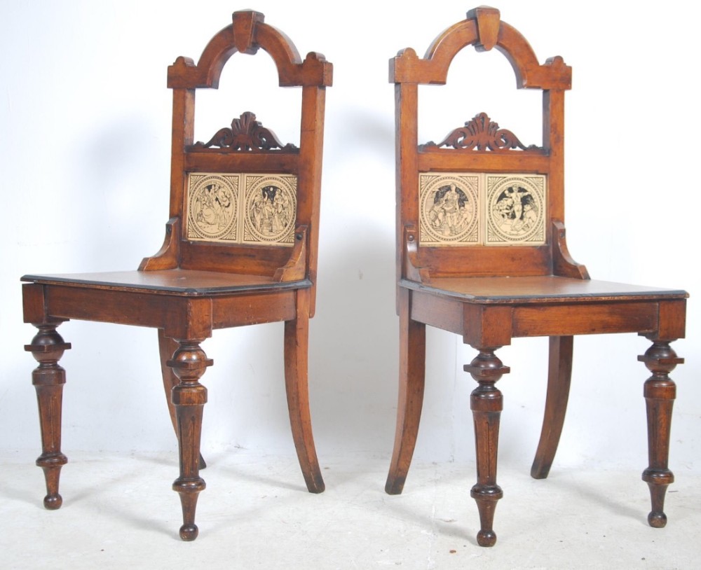 pair of oak hall chairs with with shakespeare tiles inset