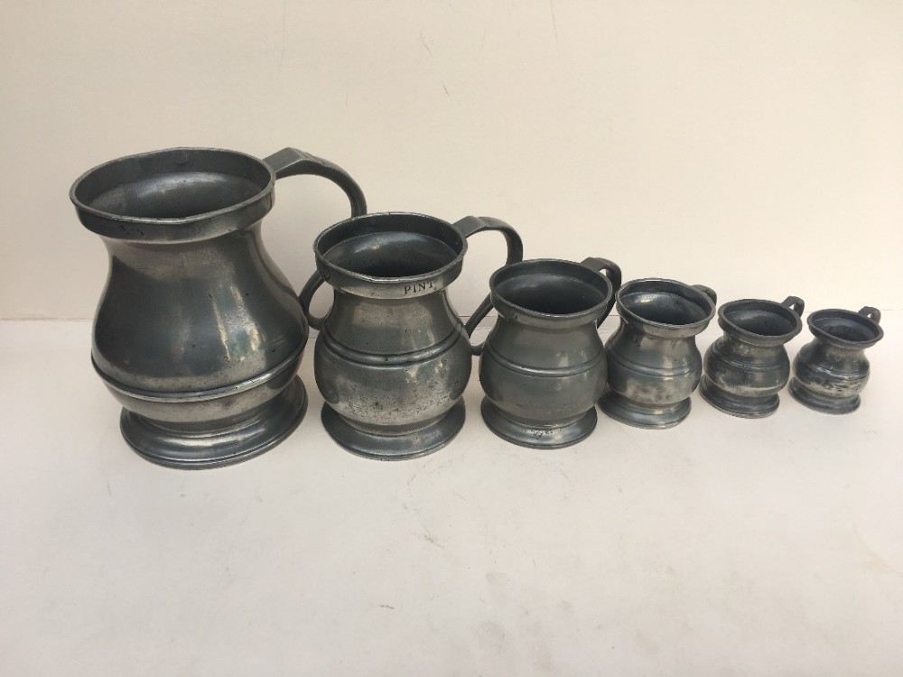 assembled set of antique pewter measures