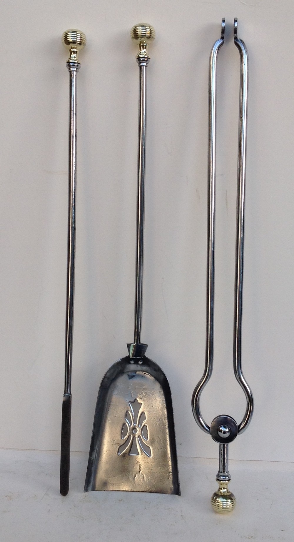 set of three steel and brass fire irons