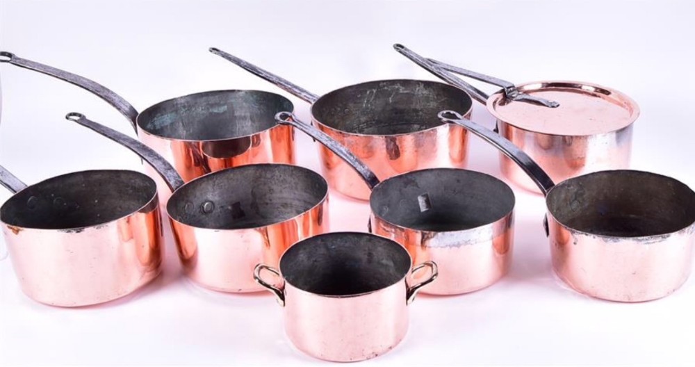 a selection of c19th polished copper saucepans