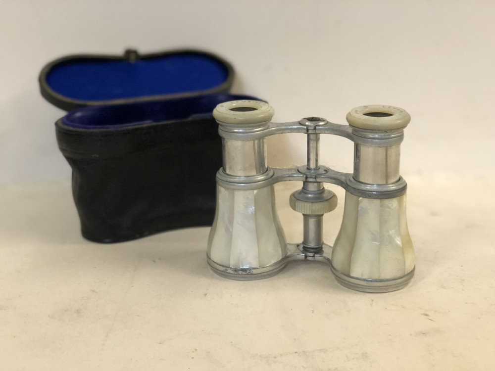 a pair of opera glasses in original case marked lemaire