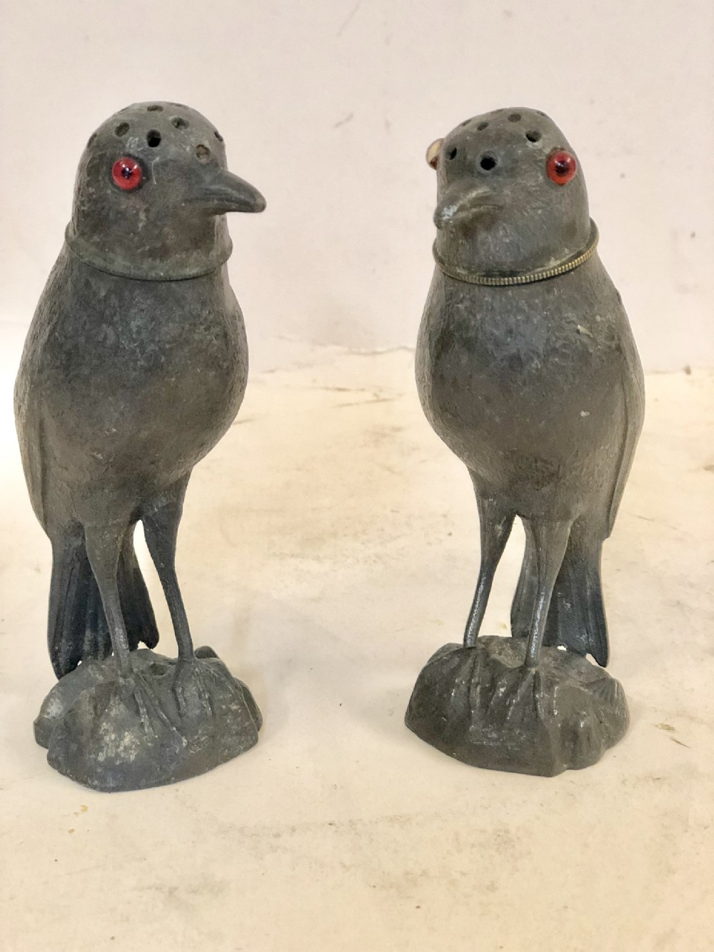 a novelty pair of spelter pepper pots modelled as birds