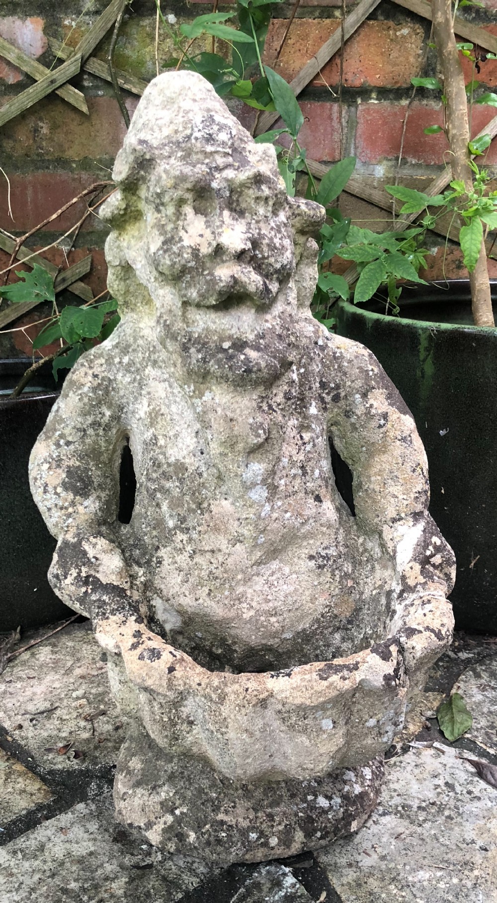 c1900 cast stone garden gnome carrying a large scallop shell