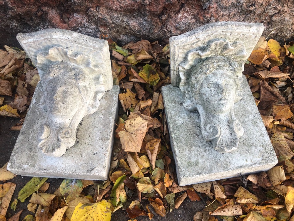 early 20th pair cast stone corbels mounted on stone backs