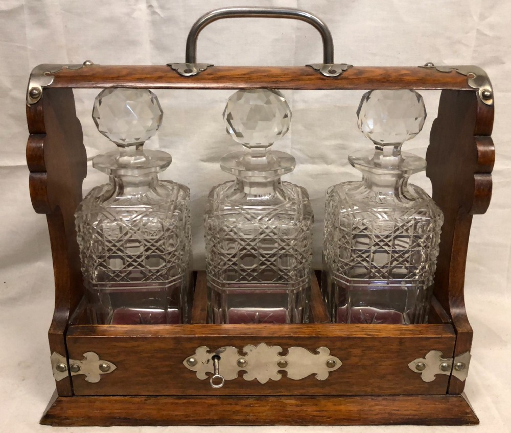 c19th oak and silver plated three bottle tantalus
