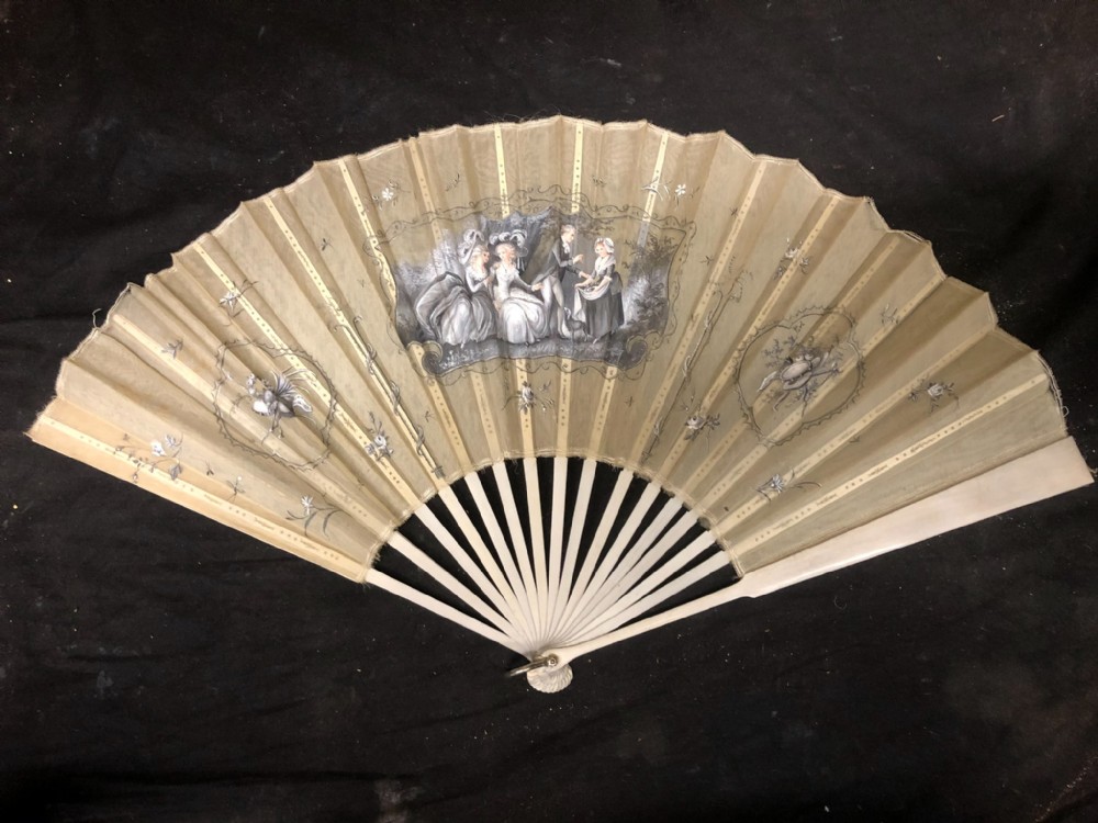 a painted fan of white gauze with papiermch guard and sticks