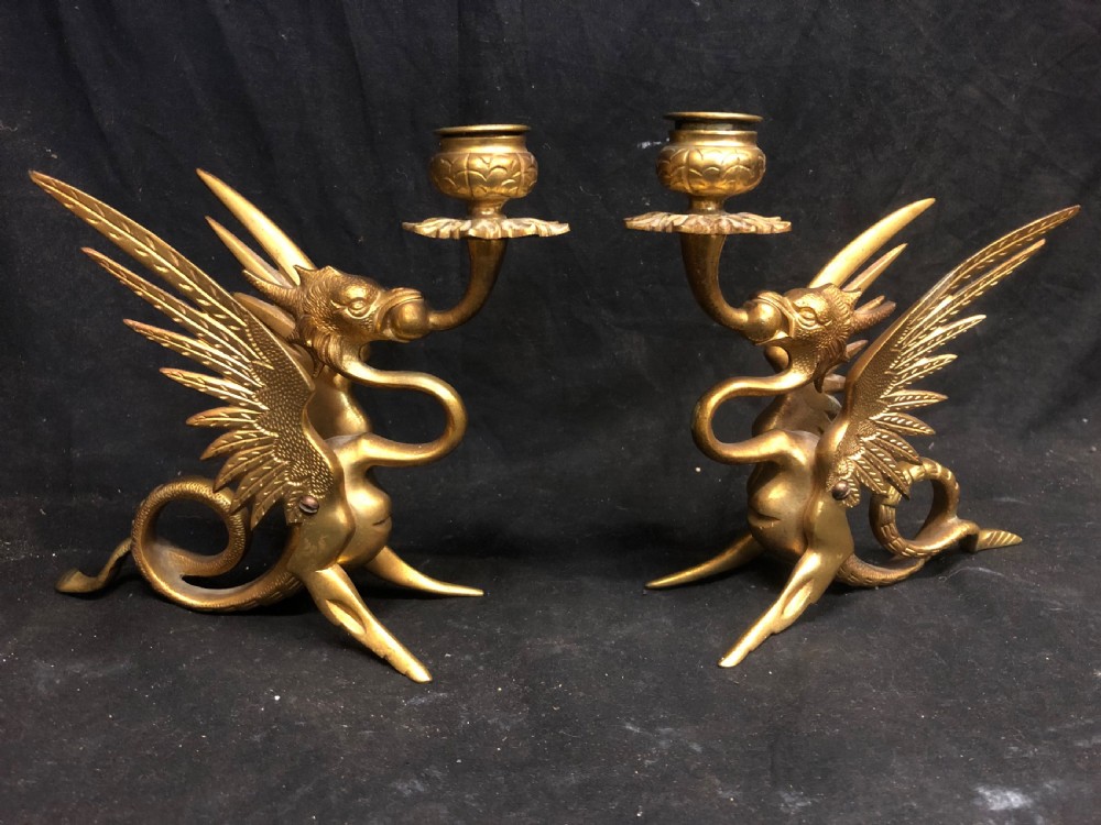 c19tg pair of gilt bronze candlesticks shaped as griffins