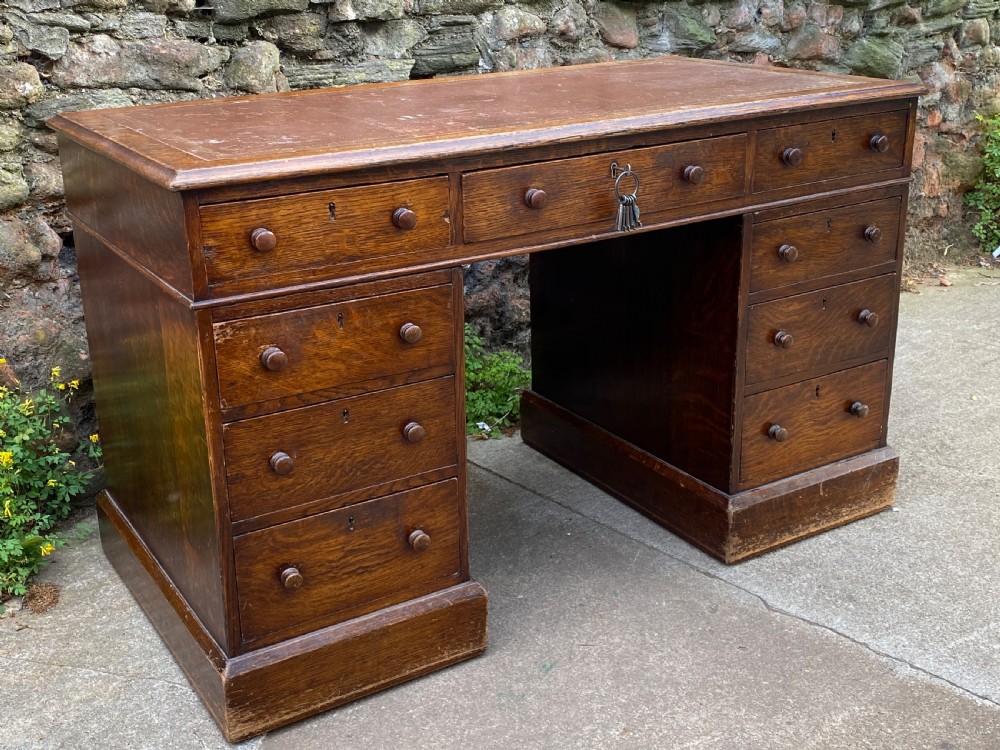 c19th oak pedestal desk of 9 drawers