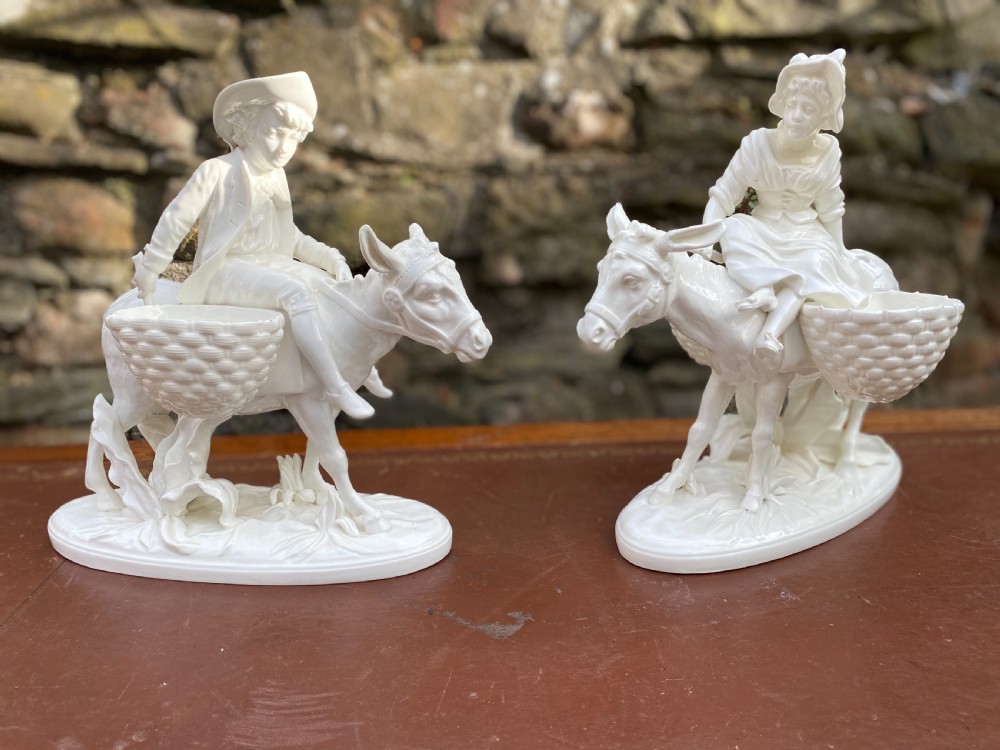 pair of figures on donkeys