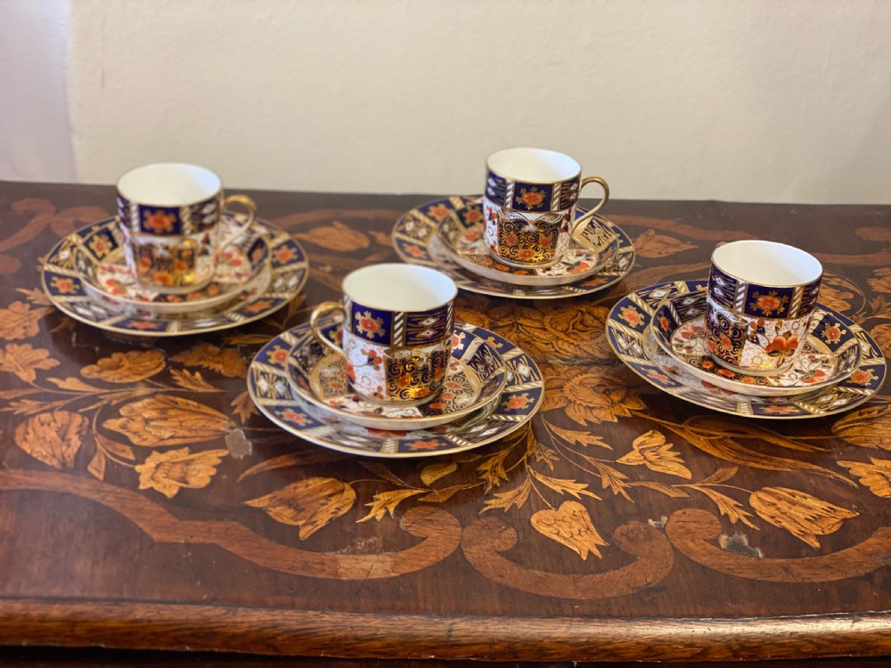 set of four imari pattern derby style coffee cans and saucers