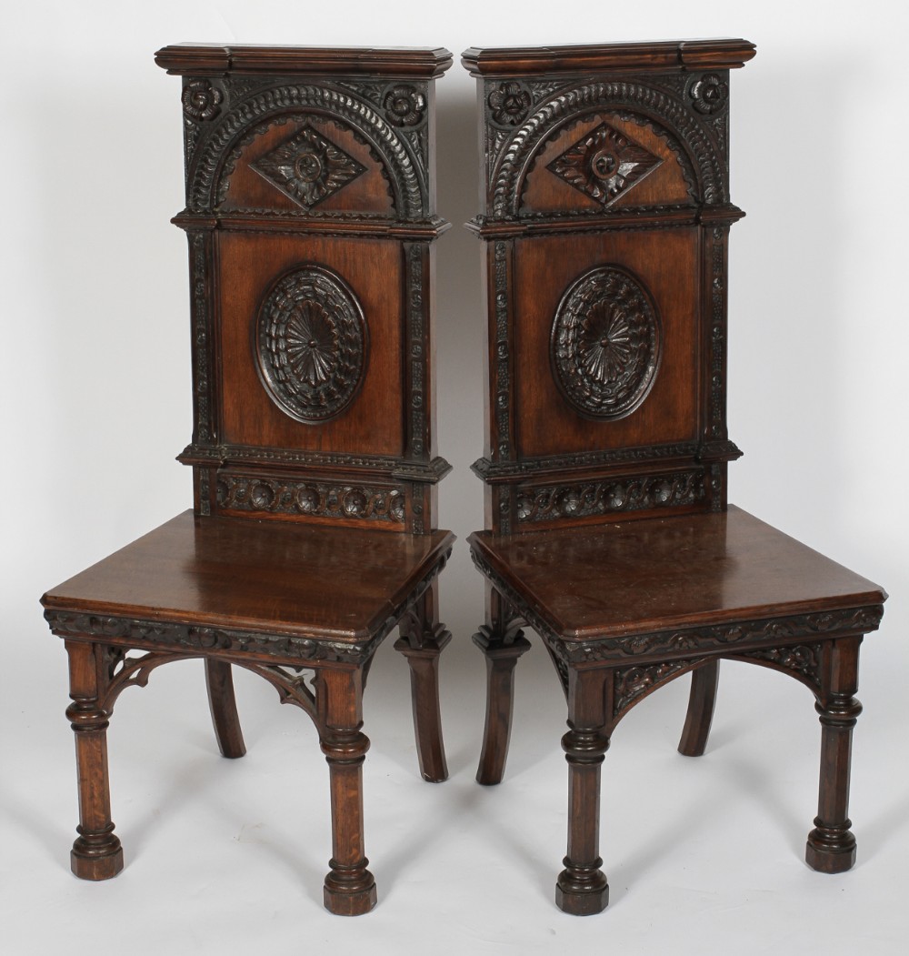 two c19th carved oak gothic hall chairs