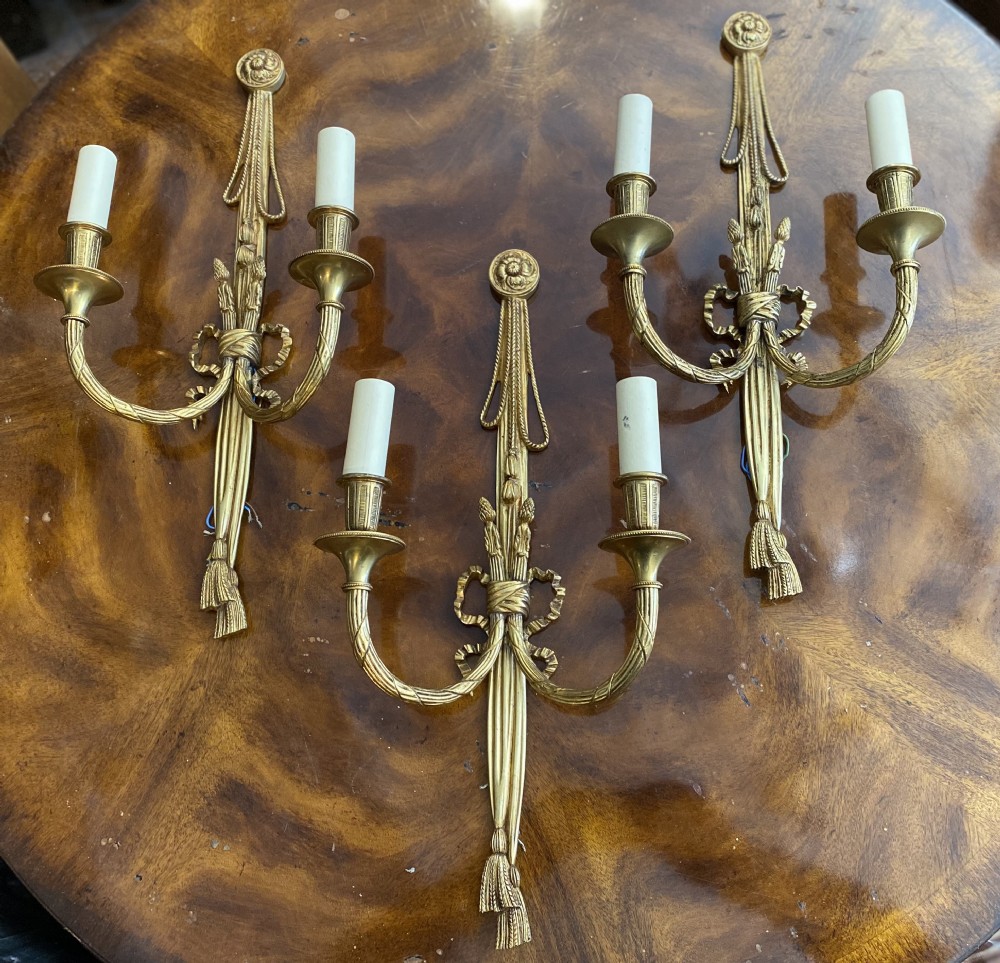 set of three classical style gilt brass wall lights