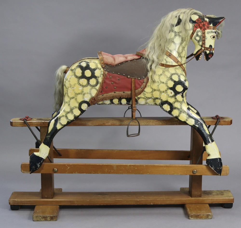 a large dapple grey painted carved wooden rocking horse on a pine trestle base by collinson sons liverpool