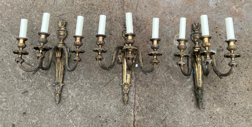 set of large three armed wall lights