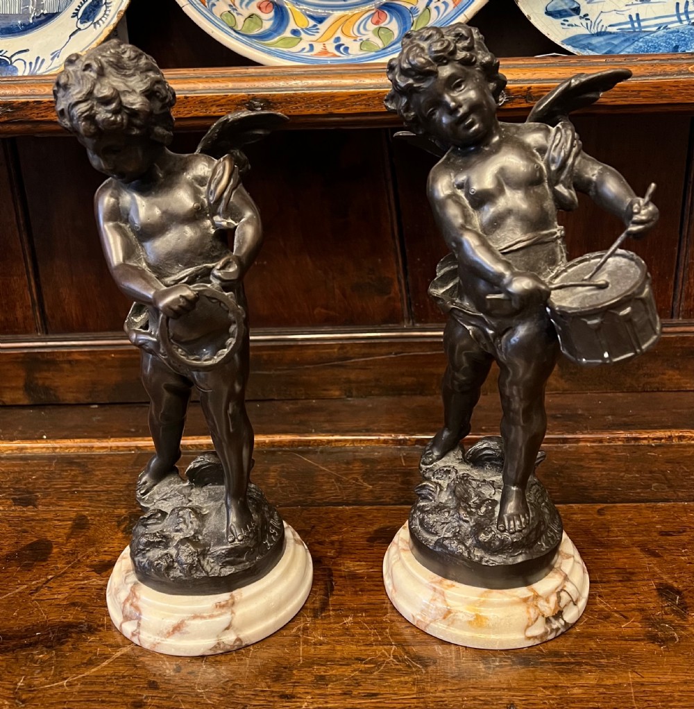 pair of bronze cherub musicians on marble bases