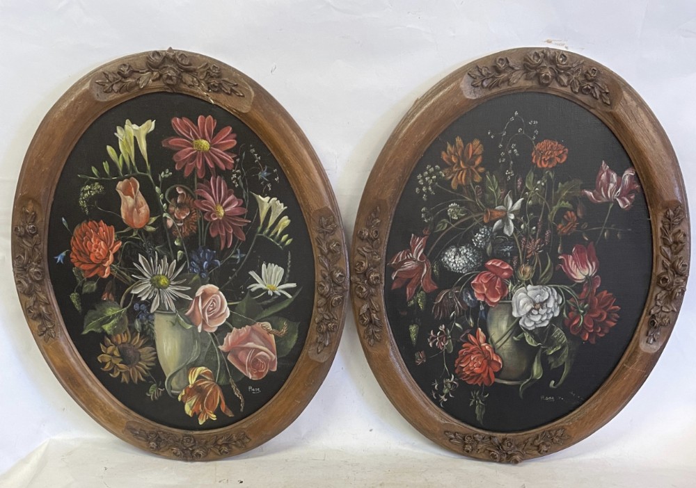 a pair of oil paintings of still lifes on board in a wood and gesso oval frame