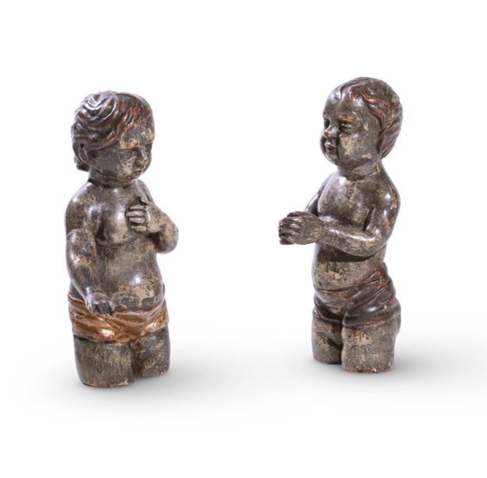 two similar polychrome silvered carved cherubic figures