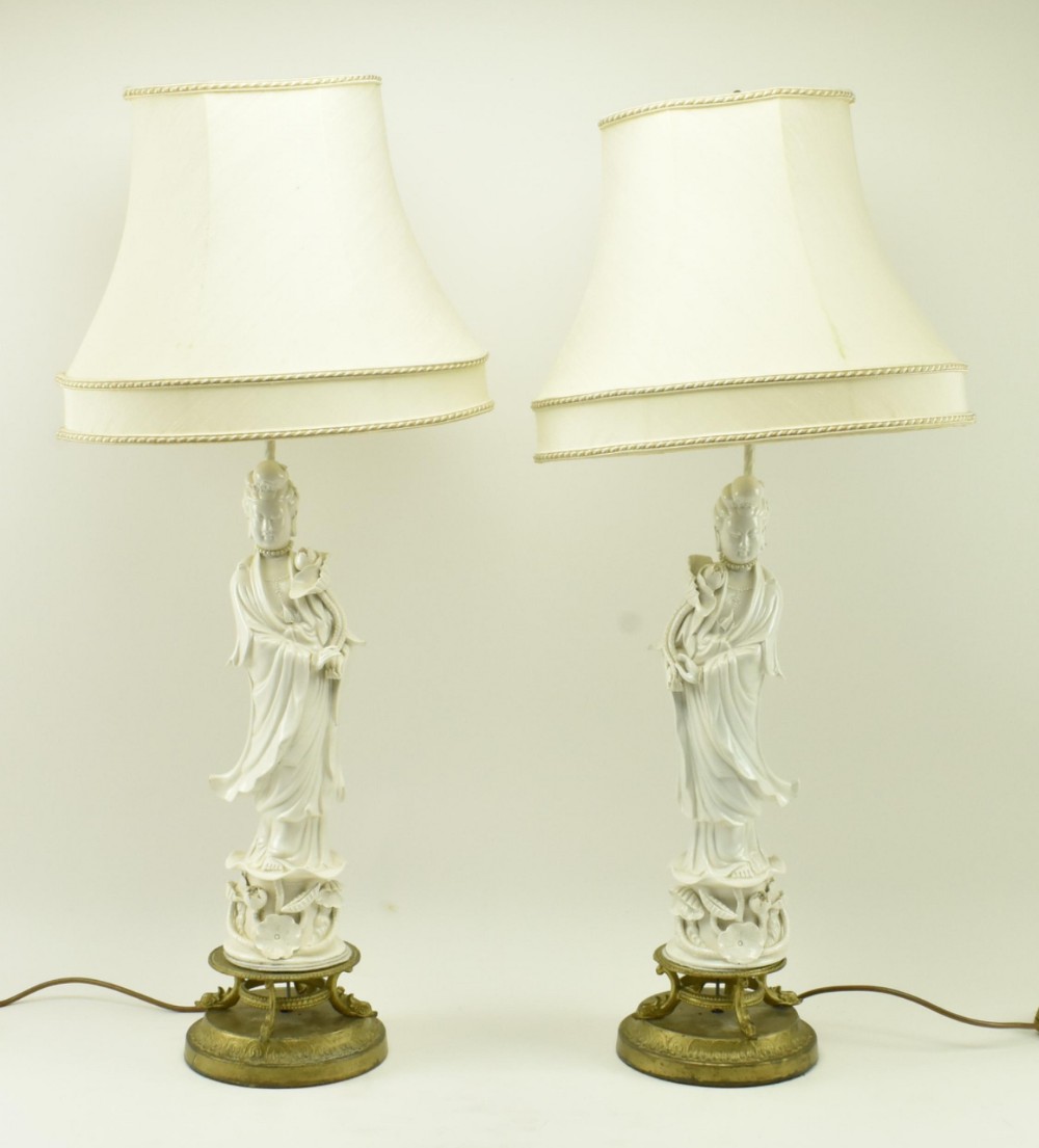 pair of blanc de chine figures on gilded metal bases