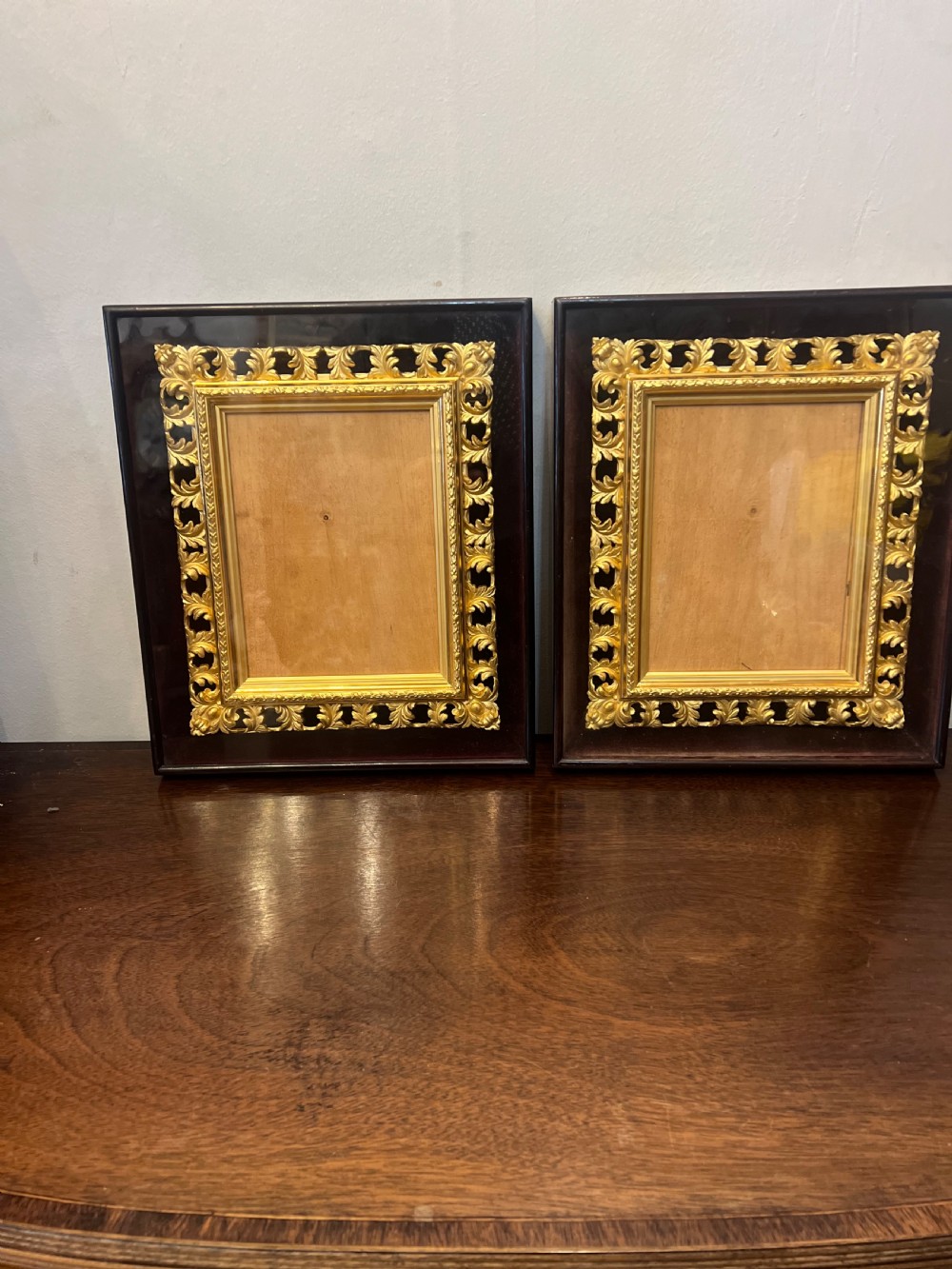 pair of c9th gilt picture frames in glass case