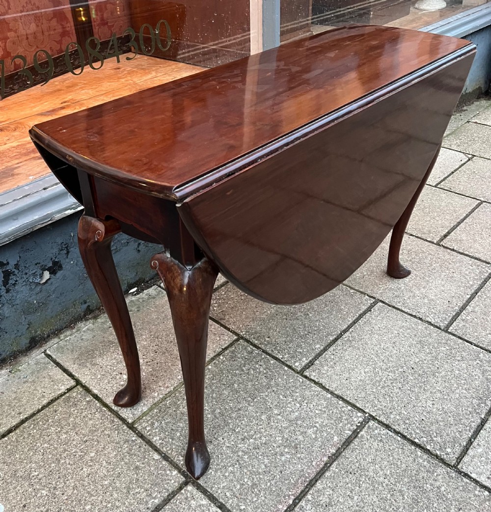 c18th cuban mahogany drop leaf table with carved cabriole legs and pointed pad feet