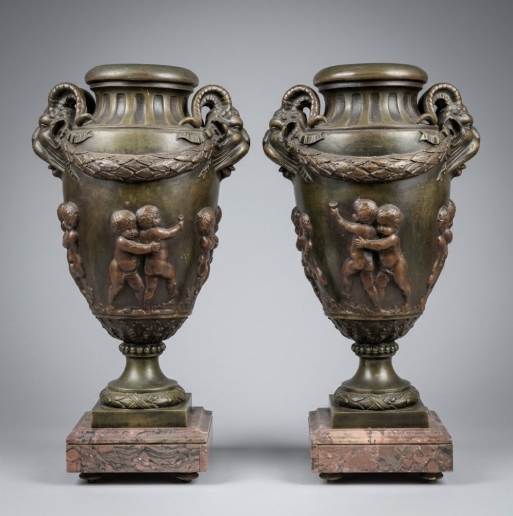 large bronzed spelter urns on marble bases